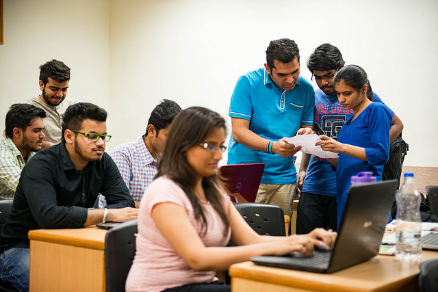 Students in a classroom with laptops open