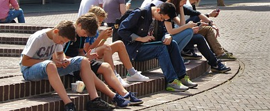 Young people sitting on concrete steps